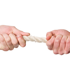 two hands tugging a rope