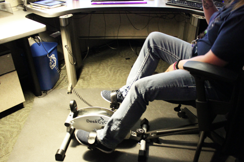 a picture of a telecommunicator using a desk cycle