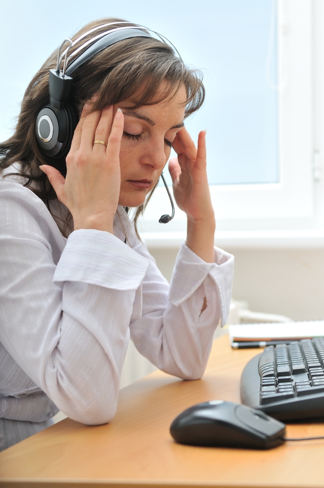 a woman in a headset looking tired