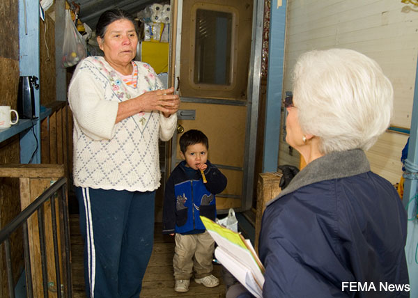 An upset woman speaking with a public health worker