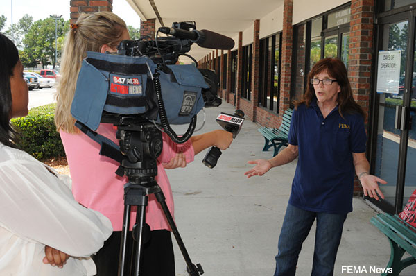 News reporter interviewing a FEMA Public Information Officer