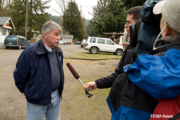 A public health worker begin interviewed by a reporter