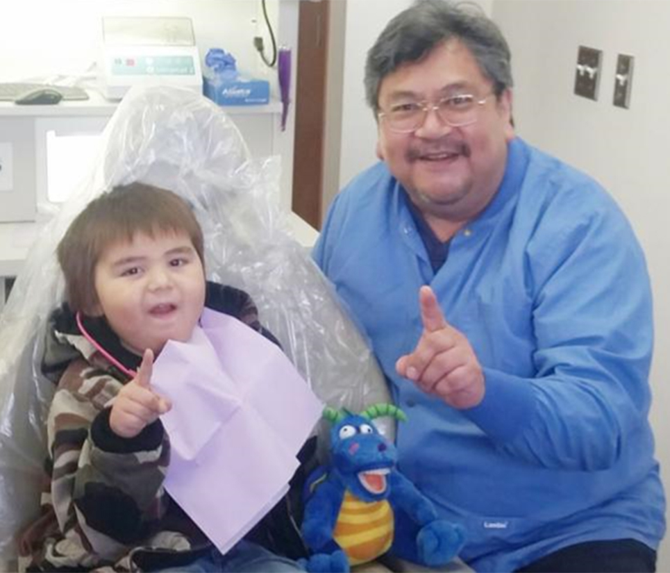 A boy and dentist at a tribal dental clinic