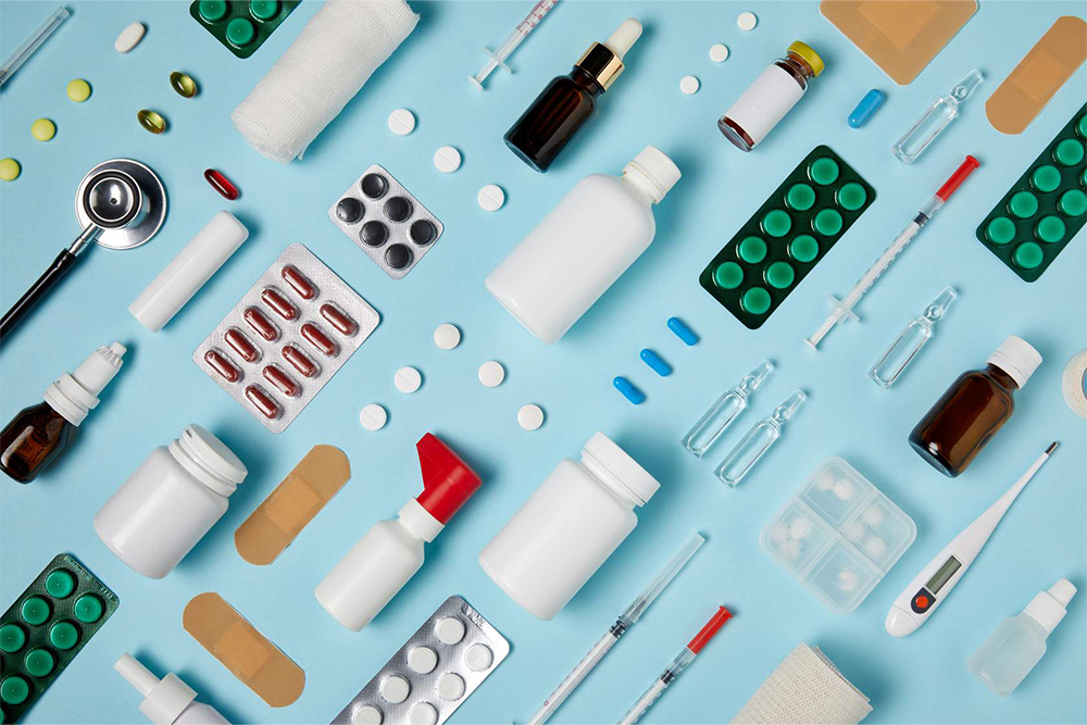 Image of pharmaceuticals laying on a diagonal grid with a teal backgroud