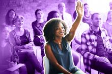 Essentially Public Health Photograph of seated student raising hand with other students in the background