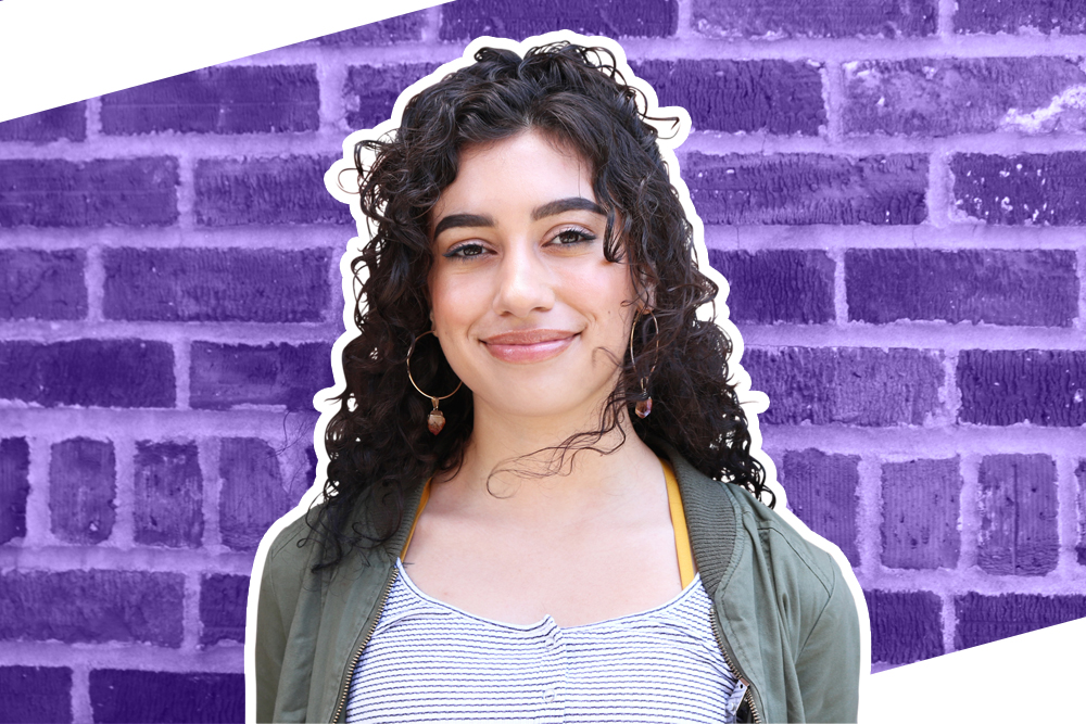 Photograph of Anavey with purple brick background