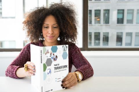 Image of woman reading the Time to Transform toolkit