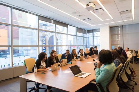 A group of people meeting in a conference room