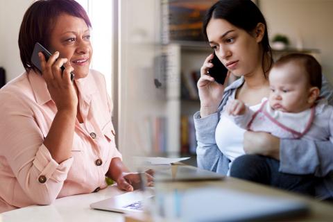 Photo montags showing a public health worker on a phone conversing with a member of the public.