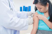 Photograph of a young girl receiving an immunization.