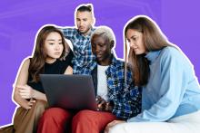 Photograph of four students looking at a laptop computer.