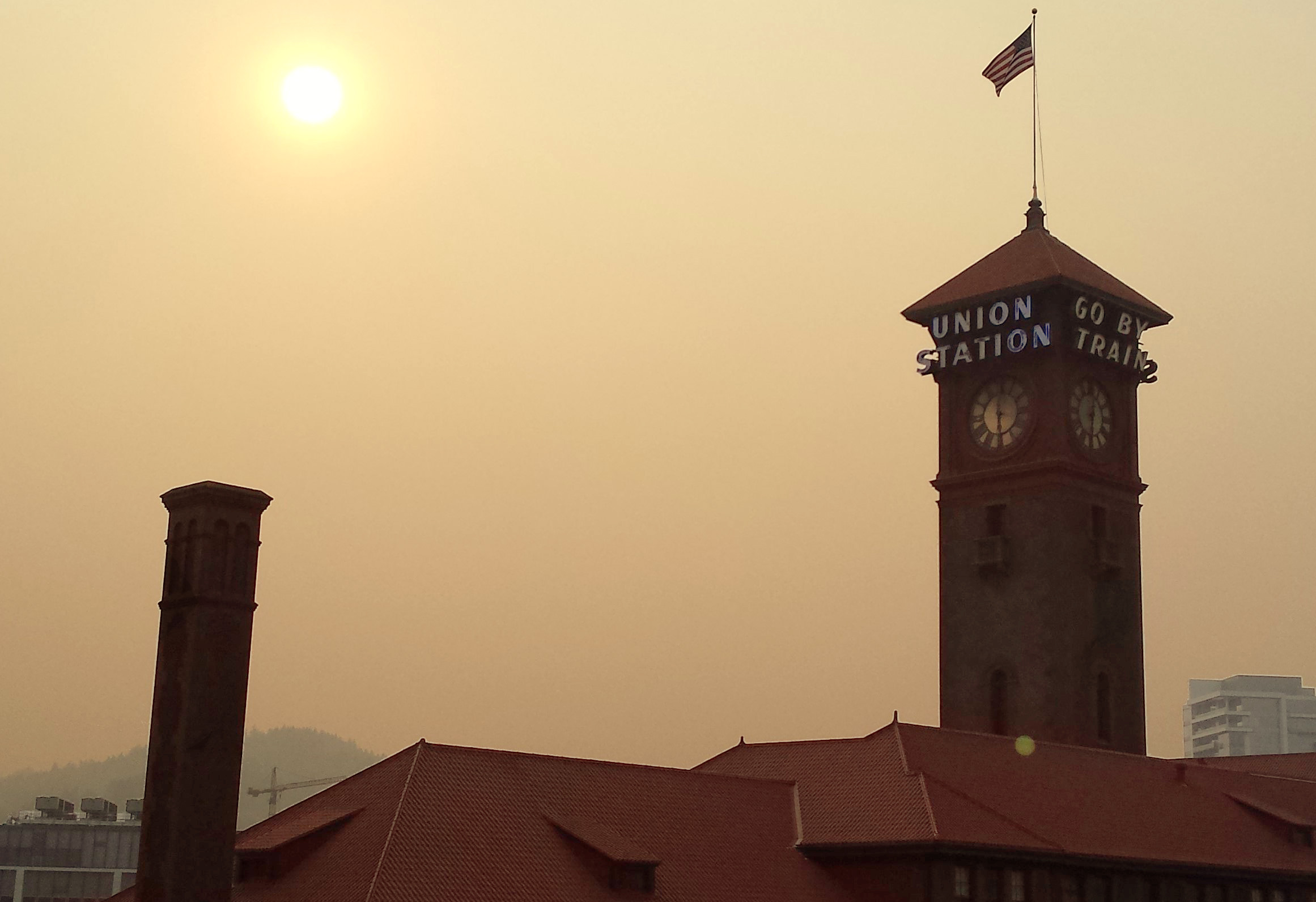 Photograph of the sky and sun obscured by smoky haze.