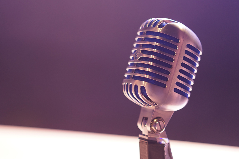 Photograph of an old-fashioned stand microphone.