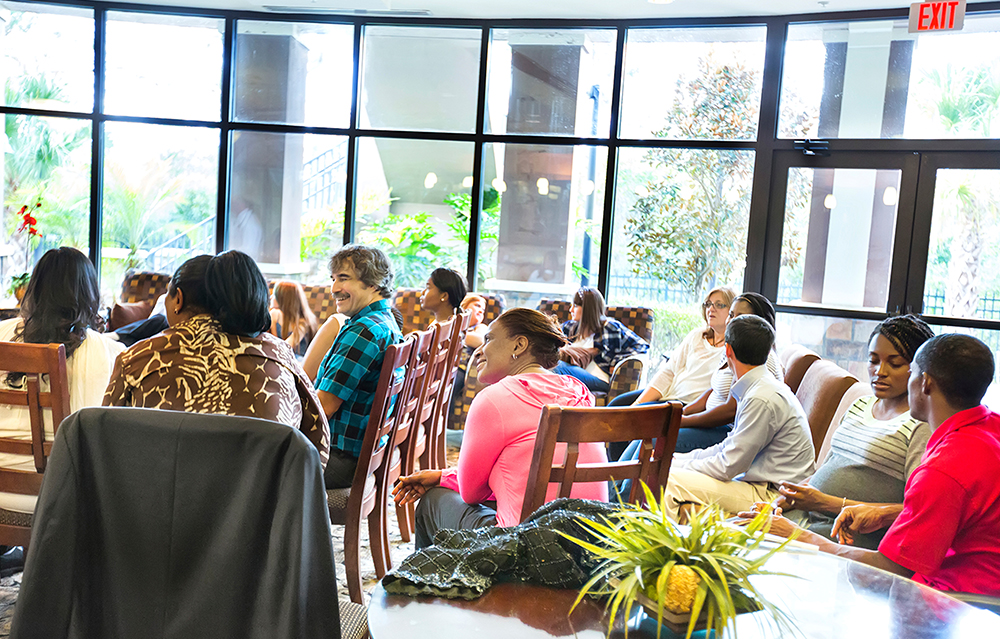 Photograph of a group of people in a listening session.