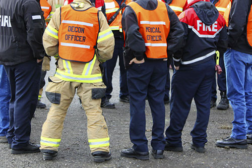 Emergency personnel from different agencies in a huddle.