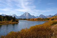 Photograph of an alpine lake with mountains in the background.