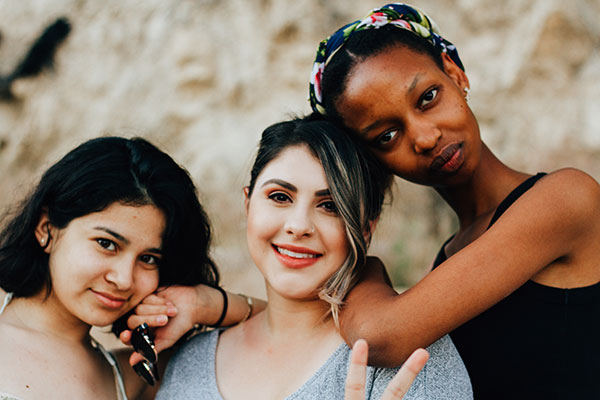 Photograph of three teens posing for a picture.